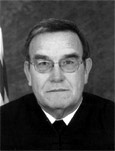JUDGE DENNIS J. BARKER
